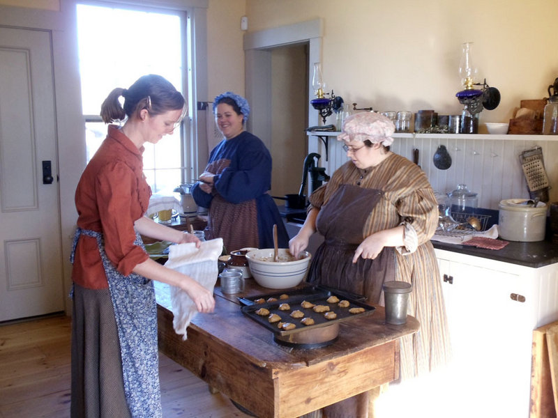 Volunteers Anne Feith, Mary Castonguay and Shelley Cox make cookies in the farmer’s cottage at the Washburn-Norlands Living History Center.