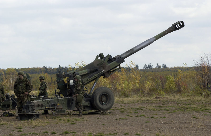 Maine Army National Guardsmen of Alpha Battery of the 1st Battalion, 152nd Field Artillery, load a round into a howitzer during training. Military veterans are concerned about exposure to defoliants and herbicides at the site.