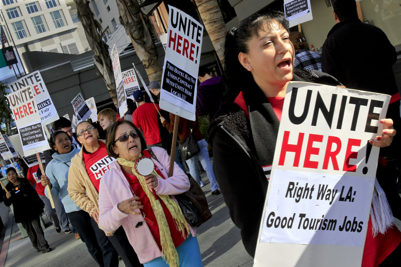 Hotel workers protest outside a Los Angeles hotel in 2011. Labor organizers who have made little headway using traditional efforts to gain pay increases are finding success with ballot measures that call for a “living wage.”