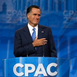 Former Republican Presidential candidate Romney puts his hand to his heart as supporters cheer him upon taking the stage to speak at the CPAC at National Harbor, Maryland