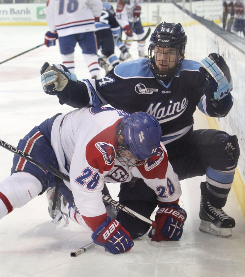 Maine’s Mark Anthoine finds himself without a stick as UMass-Lowell’s Jake Suter is on top of it while the players clash along the boards during the first period. UMass-Lowell clinched the best-of-three series with its second straight victory, 2-1 in overtime.