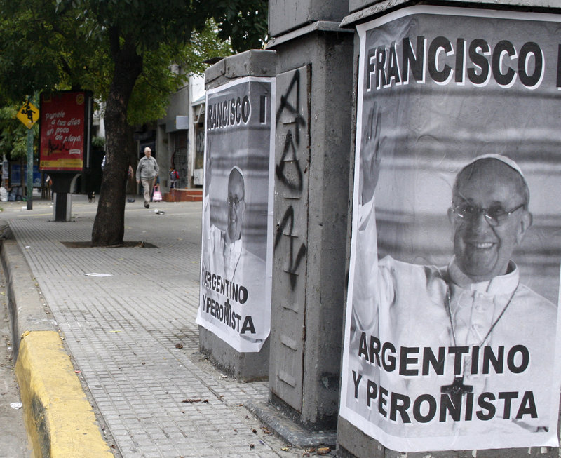 Posters celebrating the selection of an Argentine pope dot Buenos Aires. A priest at the center of a controversy over the pope’s actions during Argentina’s so-called “dirty war” says he considers the matter closed.