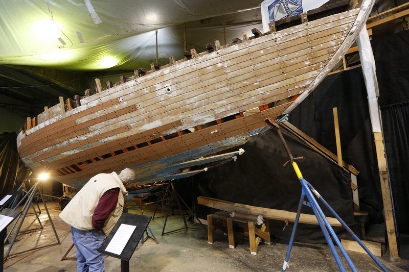 Dan Bossert of Hancock looks at the hull of Blue Heron, a 1934 Sparkman and Stephens Inc. boat, during the 26th annual Maine Boatbuilders Show in Portland.