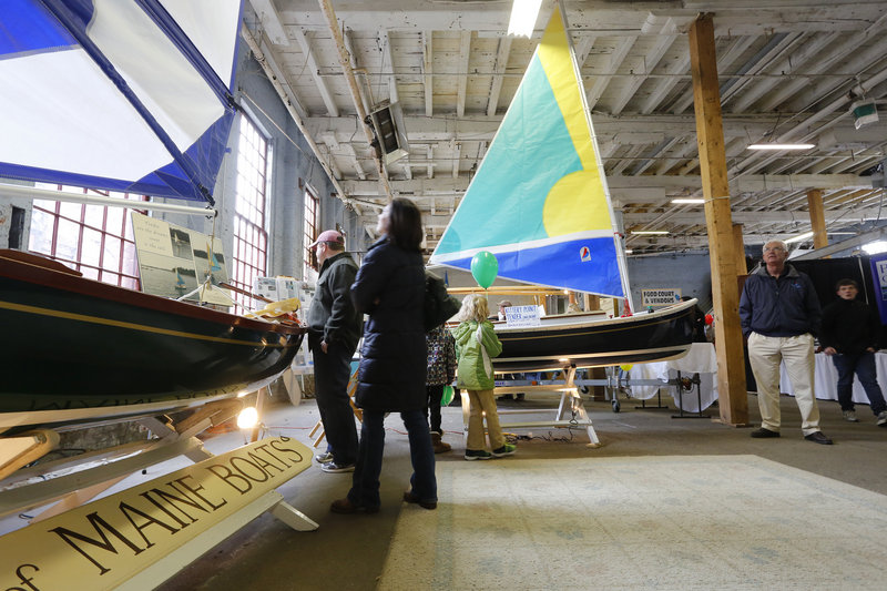 Boat enthusiasts check out custom-built tenders, made by Kennebunkport’s Bay of Maine Boats, during the 26th annual Maine Boatbuilders Show in Portland.