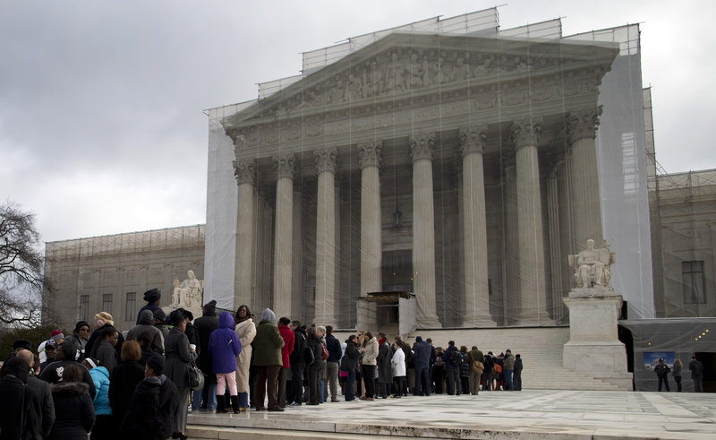 People wait in line outside the Supreme Court. In many states, taxpayer-funded public defenders face crushing caseloads, the quality of legal representation varies from county to county, and people stand before judges having seen a lawyer only briefly, if at all.