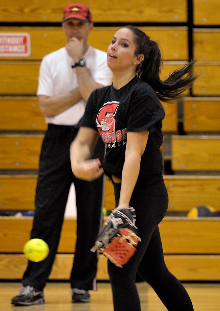 Erin Giles, a senior at Scarborough High, throws a pitch during the first day of spring practice that was held indoors because of the frigid temperature.