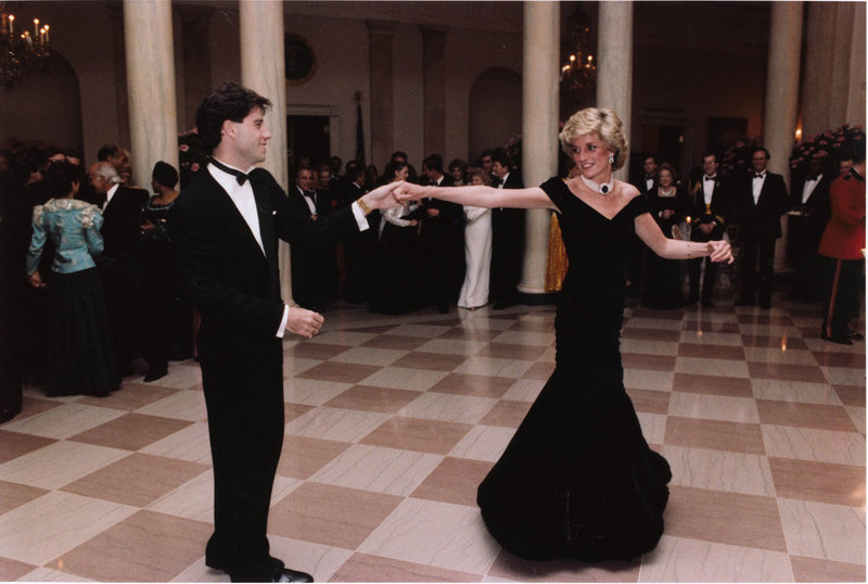 In this photo from Nov. 9, 1985, actor John Travolta dances with Princess Diana at a White House dinner. The gown she is wearing sold for $360,000 to an unnamed “British gentleman” at auction in London on Tuesday.