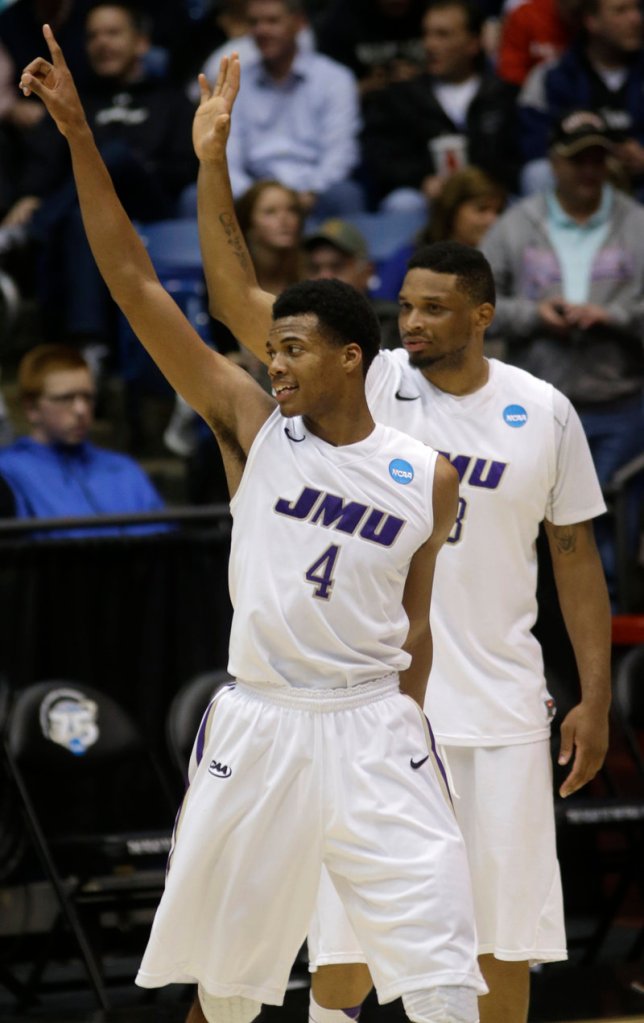Charles Cooke, front, and Rayshawn Goins of James Madison celebrate after defeating LIU Brooklyn 68-55 in a First Four game in the NCAA tourney Wednesday night in Dayton, Ohio.
