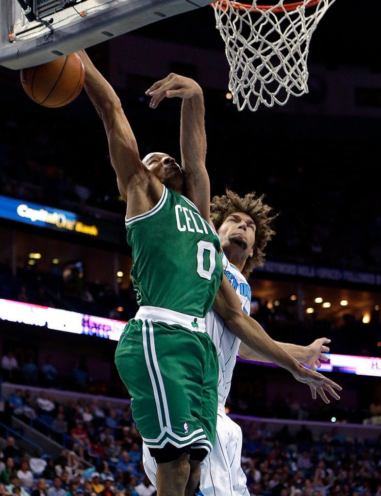 Avery Bradley of the Celts gets fouled by New Orleans’ Robin Lopez in Wednesday’s game at New Orleans. The Hornets won, 87-86.