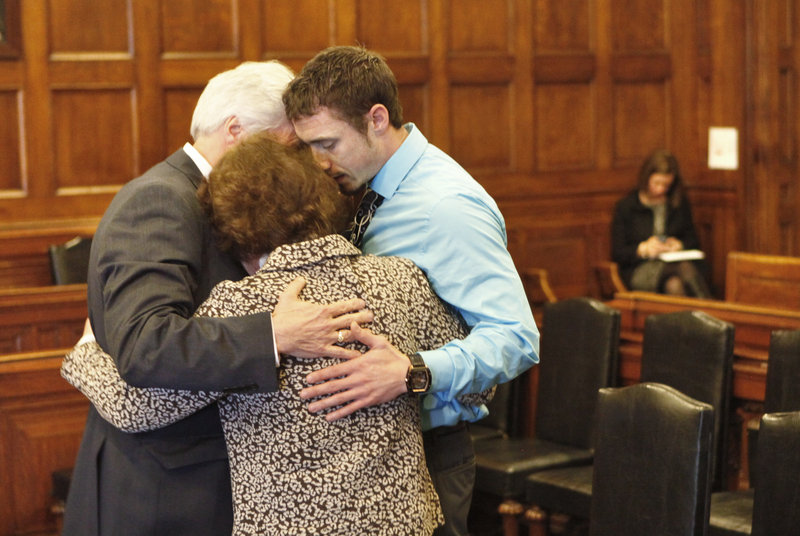 Mark Strong Sr., his wife, Julie, and their son Bradley hug during a recess in Cumberland County Unified Criminal Court in Portland on Thursday. Mark Strong was sentenced to 20 days in jail and ordered to pay $3,000 in fines.