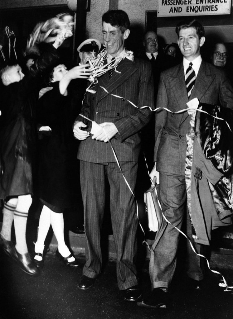 Sir Edmund Hillary, left, and his fellow New Zealander George Lowe are welcomed home to New Zealand in this Aug. 8, 1953, file photo.