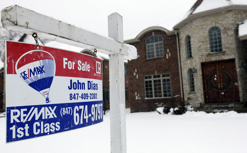 A “for sale” sign is seen outside a home in Glenview, Ill., last month. U.S. sales of previously occupied homes rose in February to the highest level in more than three years.