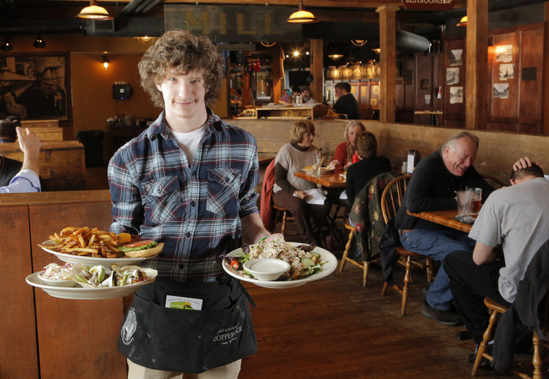 Spencer Lagerstrom delivers the Factory Island Fishwich, Fish Tacos and Chicken Salad at the Run of the Mill in Saco.