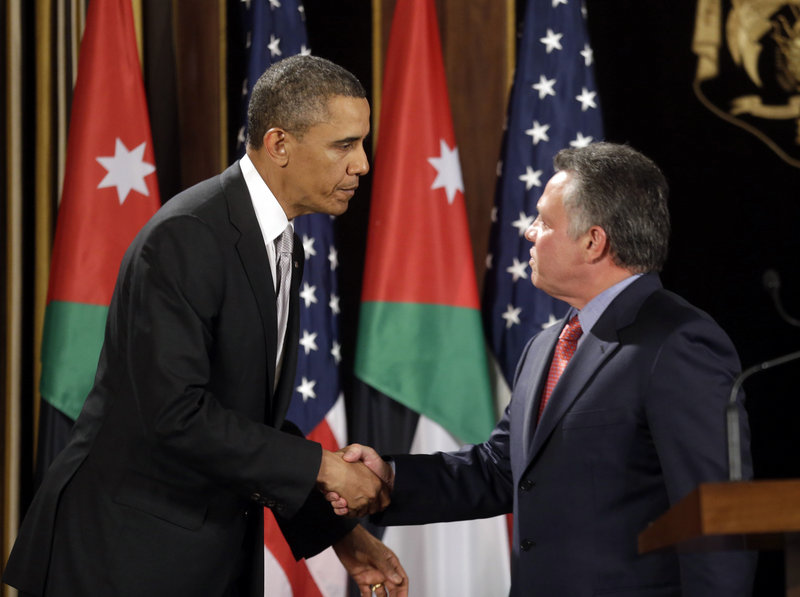 President Barack Obama and Jordan’s King Abdullah II shake hands in Amman, Jordan, on Friday. Obama said he is concerned Syria could become “an enclave for extremism.”