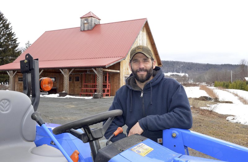 Gideon Porth, owner of Atlas Farm, stands in front of the farm stand in South Deerfield, Mass. Direct marketing is crucial for him and other New England farmers, he says.