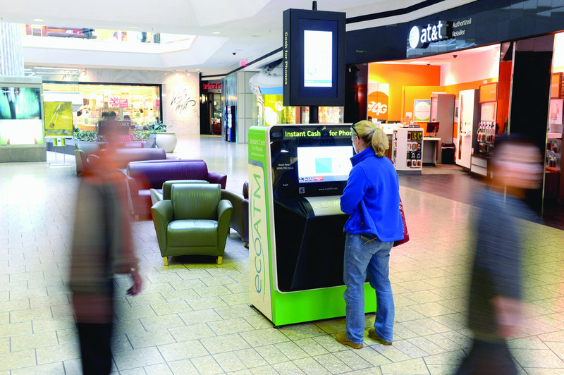 Martha Looney uses an ecoATM at Fair Oaks Mall in Fairfax, Va., on March 13 to sell four old cellphones. Police say these kiosks are also used by criminals to sell stolen phones.