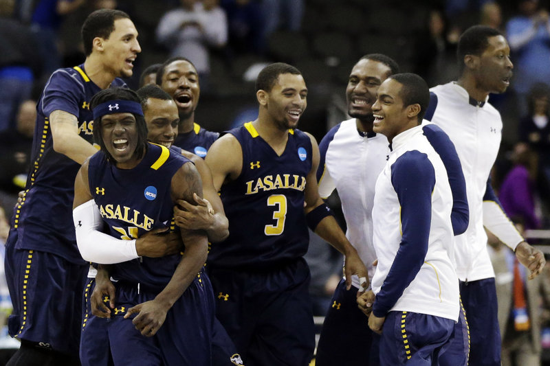 Tyrone Garland, left, celebrates with his teammates after his basket with 2 seconds remaining gave LaSalle a 76-74 win over Mississippi and a spot in the West Regional semifinals against Wichita State.