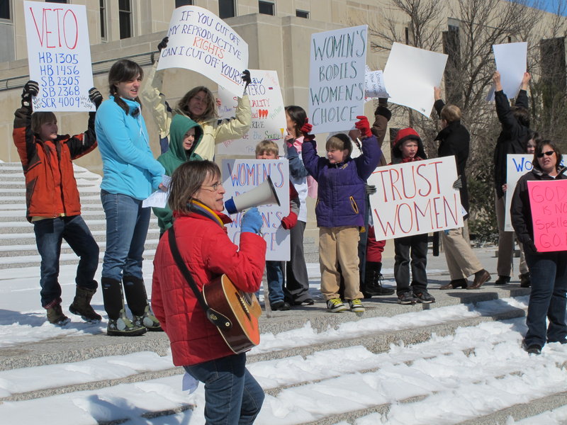 Kris Kitko leads chants of protest at an abortion-rights rally at the state Capitol in Bismarck, N.D., on Monday. Demonstrators were protesting a package of measures that would give the state the toughest abortion restrictions in the nation.