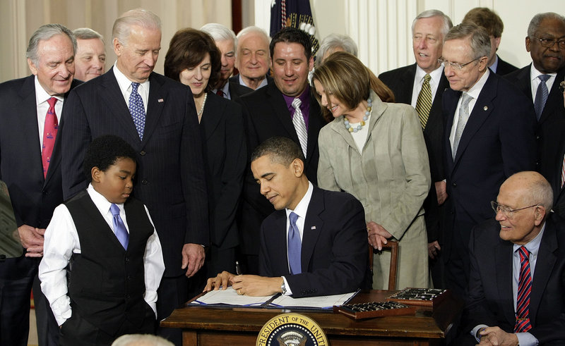 President Barack Obama signs the health care bill into law in 2010. Medical claims costs, the biggest driver of health insurance premiums, will jump about 32 percent for individual policies under the Affordable Care Act, a study concludes.