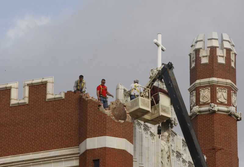 Workers inspect damage in Shawnee, Okla., on Nov. 6, 2011. A team of scientists has determined the quake was caused when oil drilling waste was injected deep underground.