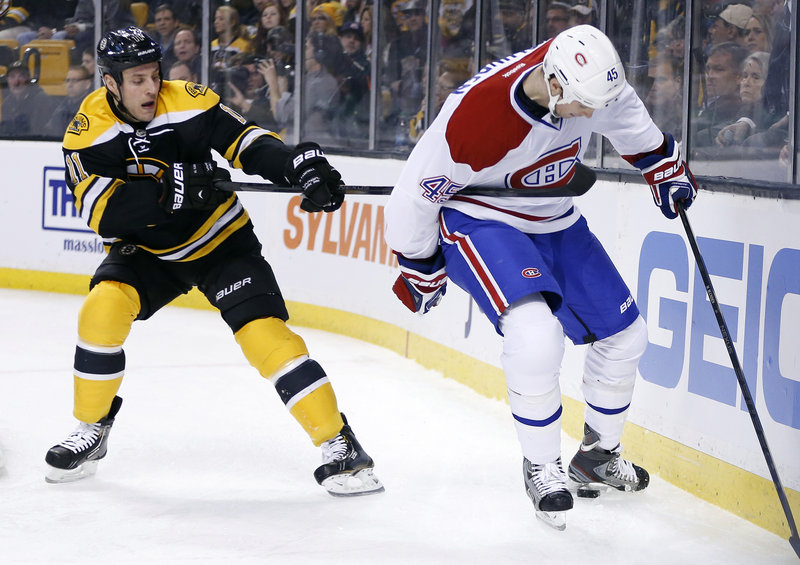 Gregory Campbell of the Bruins hooks Montreal’s Michael Blunden in the first period Wednesday night in Boston. The Canadiens rallied, then won in a shootout, 6-5.