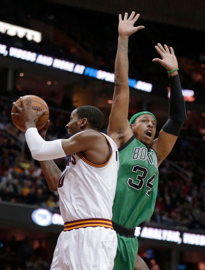 C.J. Miles of the Cleveland Cavaliers controls the ball Wednesday night in front of Paul Pierce of the Boston Celtics during Boston’s 93-92 victory.