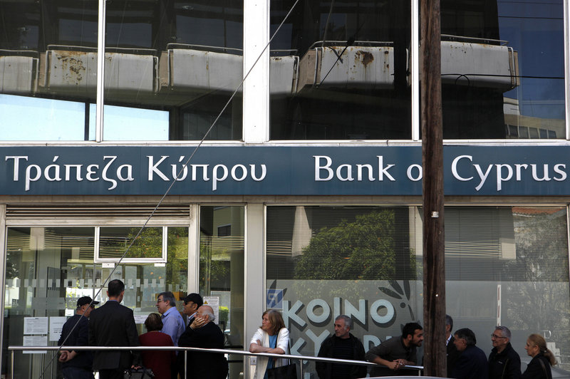 Customers wait Thursday outside a branch of the Bank of Cyprus in Nicosia as Cypriots got their first chance to access their savings in two weeks.