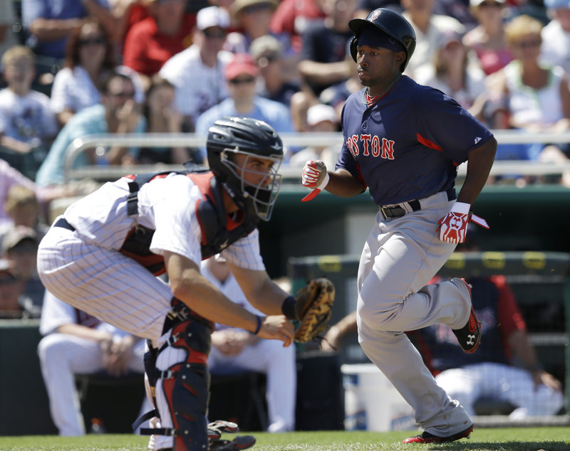 Jackie Bradley Jr. scores on a single by Dustin Pedroia as Minnesota catcher Eric Fryer awaits the throw in the sixth inning Friday. The Twins beat the Red Sox, 8-3.
