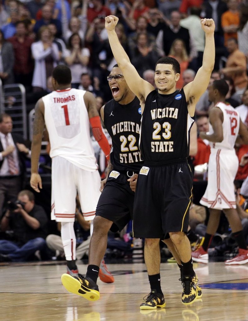 Wichita State's Carl Hall (22) and Fred Van Vleet celebrate their team's 70-66 win over Ohio State in the West Regional final in the NCAA men's college basketball tournament Saturday in Los Angeles. Ohio State's Deshaun Thomas (1) walks off at left.