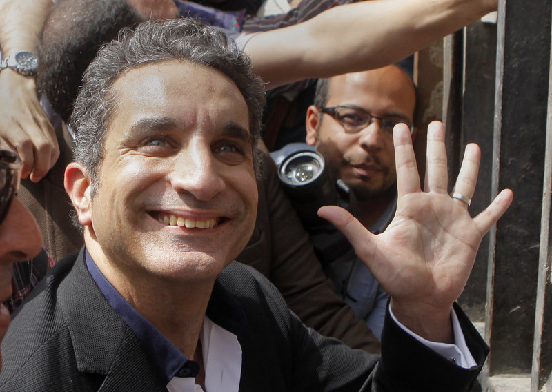Bassem Youssef, who has come to be known as Egypt’s Jon Stewart, gestures as he enters a prosecutor’s office to face accusations of insulting Islam and the country’s Islamist leader.