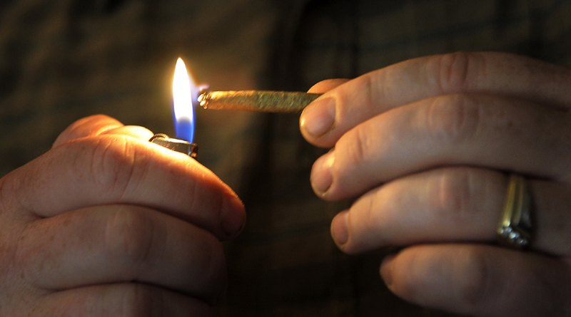 Glenn Lewis lights a joint in his Manchester, Maine home in October 2012. The Portland Green Independent Committee is seeking to legalize the possession of up to 2.5 ounces of marijuana in Portland.