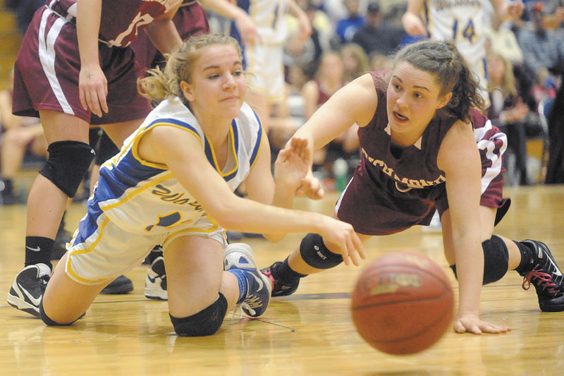 Washburn's Carmen Bragg, left, battles for a loose ball with Haley Murphy of Richmond in the fourth quarter in the Class D girls' basketball state championship game Saturday at the Bangor Auditorium. Washburn beat Richmond for the third straight year, 75-55.