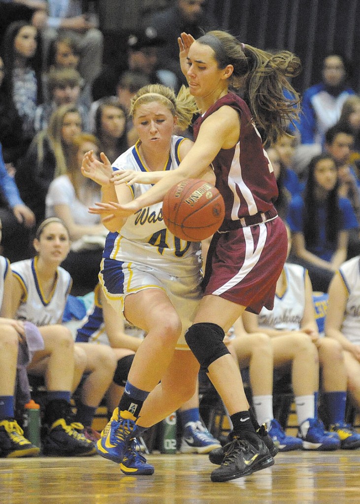 Richmond's Jamie Plummer, 15, defends Washburn's Nicole Olson, 40, in the fourth quarter of the Class D state championship game at the Bangor Auditorium Saturday. Washburn defeated Richmond 75-55 for the state title.