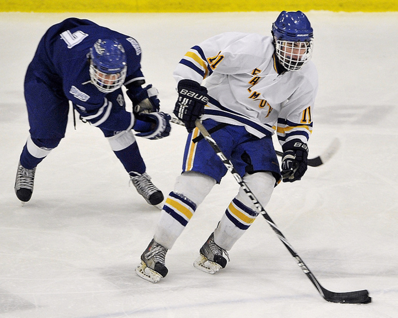 Falmouth's William Mullin takes the puck from Lewiston's Cam Marquis and heads for a breakaway.