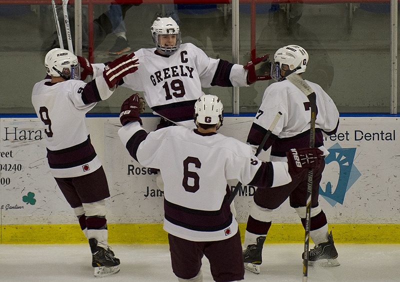 Ted Hart, 19, welcomes his teammates Wednesday night after scoring the first goal of the game – and the first of his three – to help Greely down Camden Hills 7-1 in the Western Class B championship game at Lewiston.