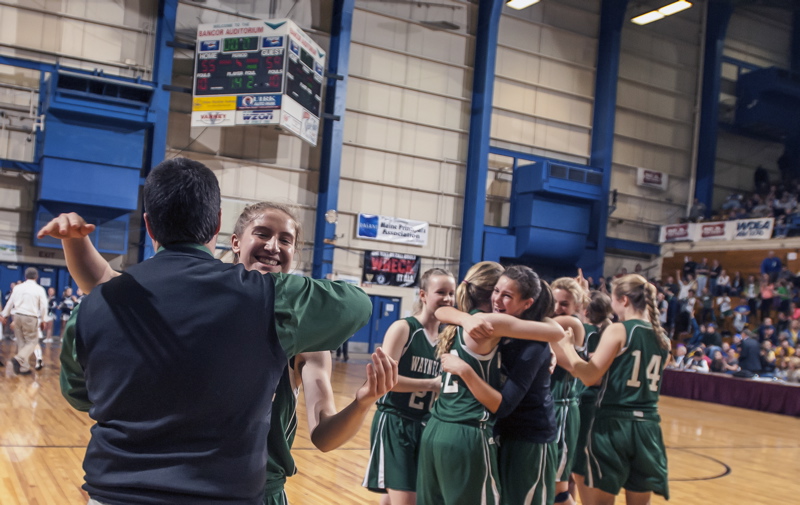 Martha Veroneau, who scored 34 points, including the final 16 for Waynflete, embraces Coach Brandon Salway after the Flyers rallied past Calais to win the Class C state title.