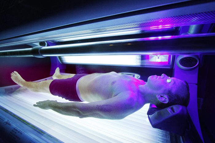 A customer uses a tanning bed at a South Portland tanning salon in this 2010 photo. The American Academy of Pediatrics in 2011 said that anyone younger than 18 should be banned from tanning salons because of the risk of skin cancer.