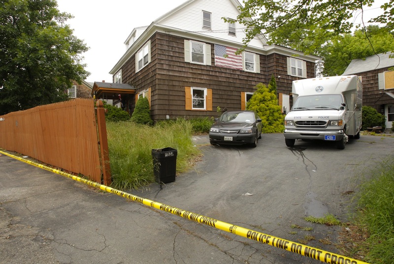 In this July 2009 file photo, police search then-alleged killer Rory Holland's house at 58 South St. in Biddeford. The home, which fell into disrepair, has been demolished and will become a park.