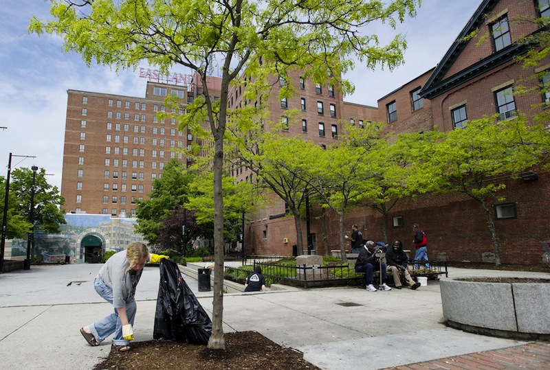 Dawn York of South Portland picks up trash in Congress Square Plaza in this Tuesday, May 22, 2012 file photo. An Ohio hotel developer is working on a new plan to buy a portion of Congress Square Plaza so it can build a facility to host events at the adjacent Eastland Hotel.
