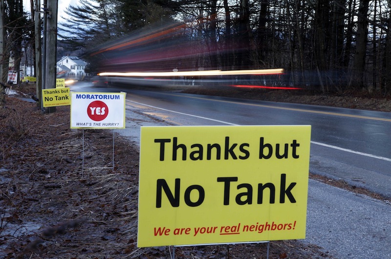 In this Friday, March 9, 2012 photo, signs in opposition to a proposed 23-million gallon propane tank are seen in Searsport, Maine. (AP Photo/Robert F. Bukaty)