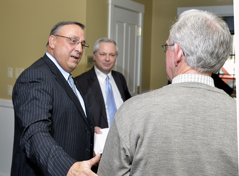 Gov. Paul LePage speaks with Charles Wallace, president of Resource Systems Engineering, at a Brunswick chamber event Wednesday. Economic adviser John Butera is in the middle.