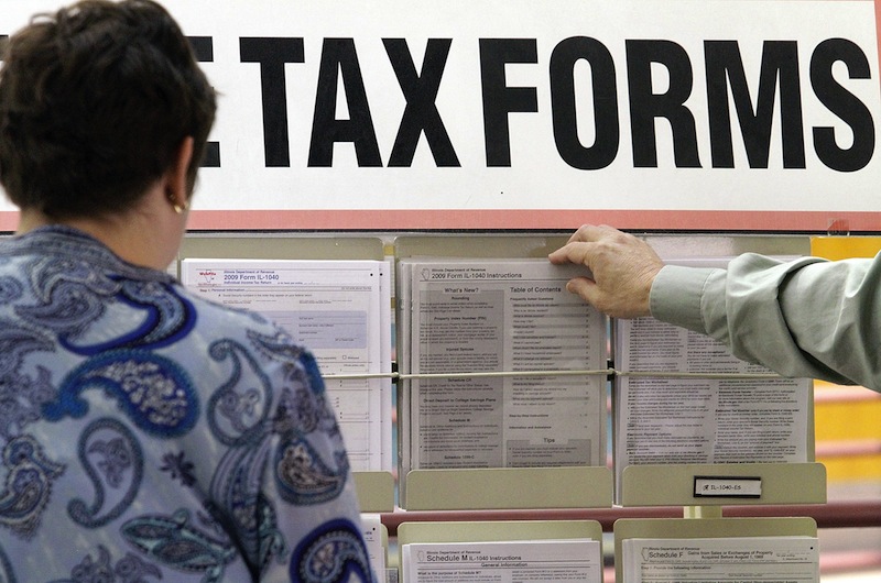 In this April 15, 2010 file photo, taxpayers sift through tax forms a government office. Maine will become one of five states to consider sweeping tax changes this year when a bipartisan coalition of lawmakers releases its highly anticipated reform plan Wednesday. (AP Photo/Seth Perlman)