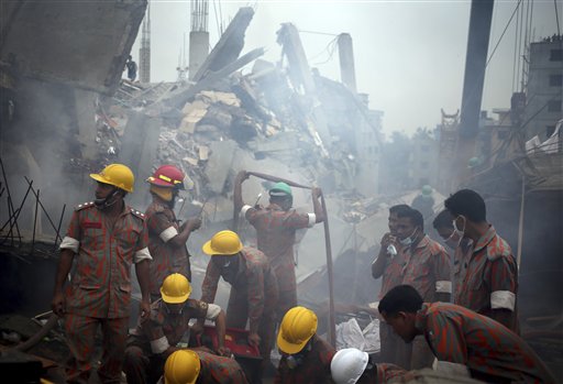 Workers and firefighters prepare to dislodge debris and the fallen ceiling of the garment factory building that collapsed in Savar, Bangladesh. Rescue workers gave up hopes of finding any more survivors in the remains of the building that collapsed five days ago, and began using heavy machinery on Monday to dislodge the rubble and look for bodies.