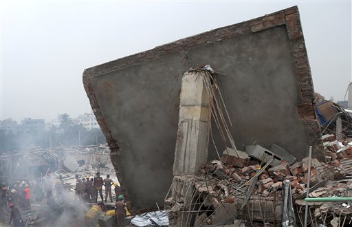 Rescue and recovery personnel prepare to dislodge the ceiling of the garment factory building that collapsed on Wednesday in Savar, Bangladesh,