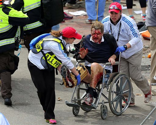 Medical workers aid an injured man at the 2013 Boston Marathon following the explosion in Boston on Monday.