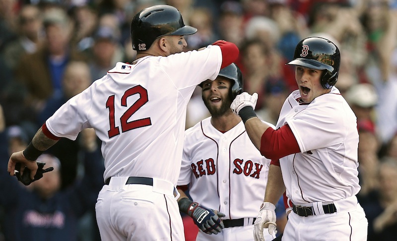 Boston Red Sox's Daniel Nava, right, is greeted by Dustin Pedroia and Mike Napoli (12) after hitting a three-run home run during the seventh inning of a baseball game against the Baltimore Orioles at Fenway Park in Boston, Monday, April 8, 2013. (AP Photo/Winslow Townson)