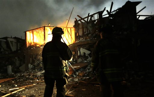 Firefighters use flashlights early Thursday morning to search a destroyed apartment complex near the fertilizer plant that exploded Wednesday night in West, Texas.