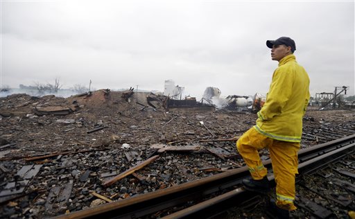 A firefighter surveys the remains of a fertilizer plant destroyed by the massive explosion at the West Fertilizer Co.
