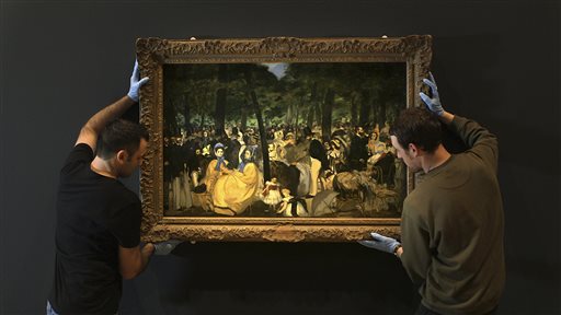 Employees of the Royal Academy of Art move a Manet painting at the Royal Academy of Arts in London. On April 11, films about art exhibitions from around the world will open in select movie theaters and performing arts centers in nearly 30 countries.