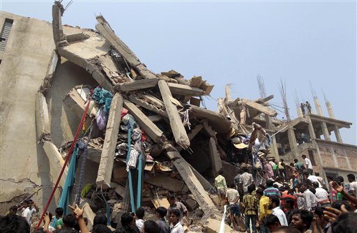 Rescue workers and people look for survivors after an eight-story building housing several garment factories collapsed in Savar, Bangladesh, on Wednesday. An enormous section of the concrete structure appeared to have splintered like twigs.